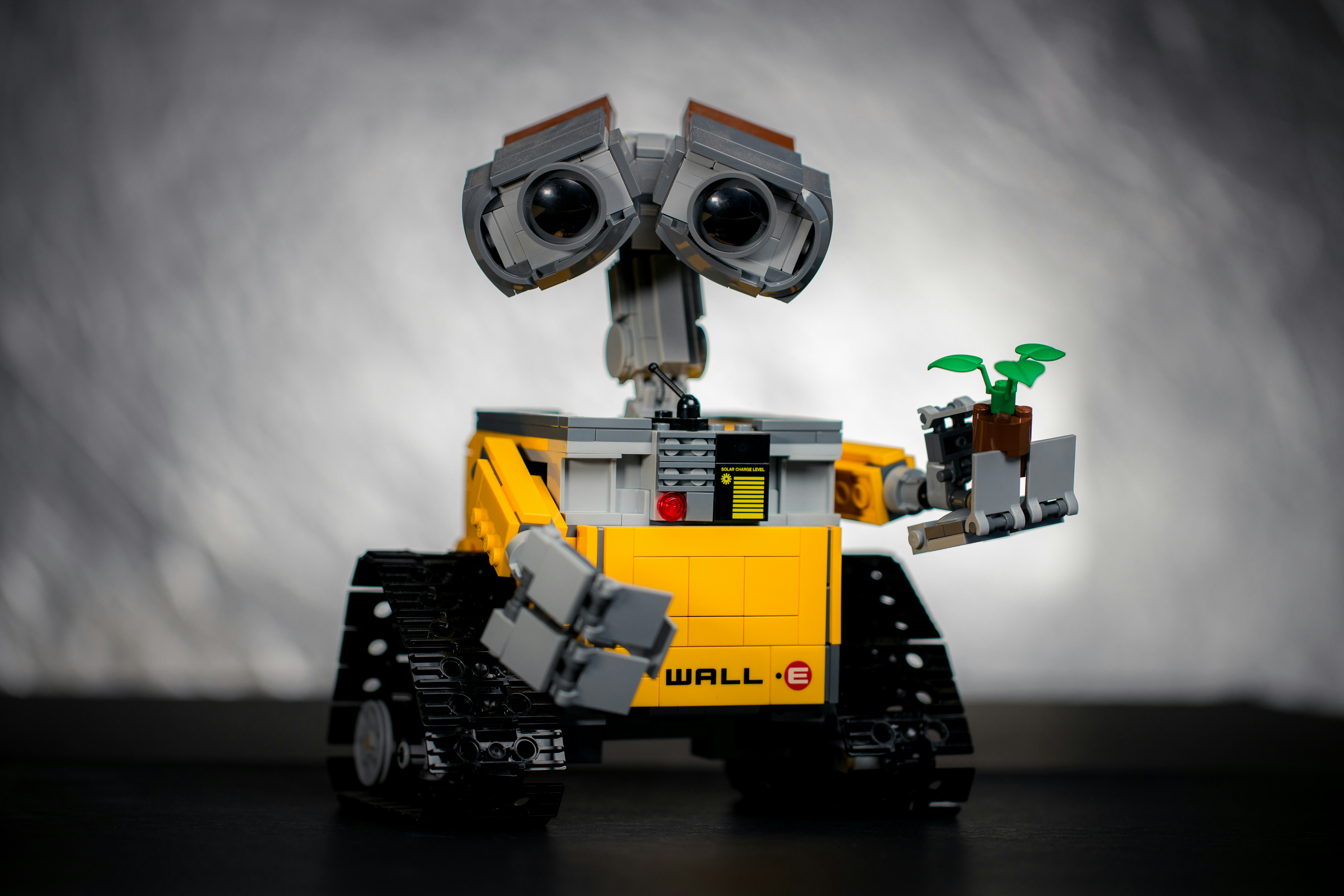 A person performing maintenance on an Optimus Gen 2 robot, with tools and spare parts visible